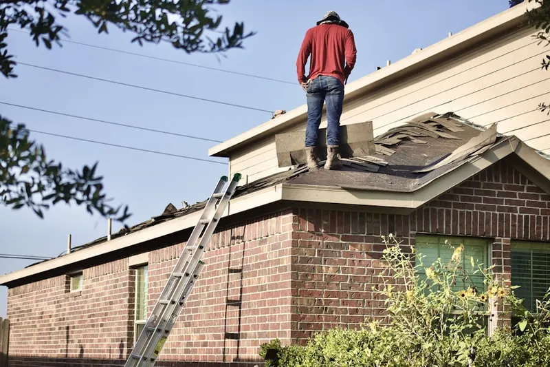 Professional roofer working on a residential roof in Childrens Village of the Hartford Orphan Asylum